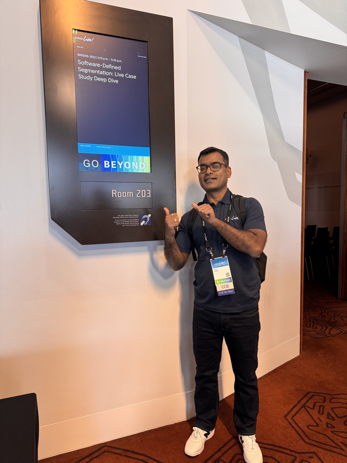 Amit Singh beside Cisco Live room signage for BRKENS-2823